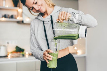 Woman Making Detox Smoothie At Home