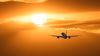 Plane is taking off at sunset.