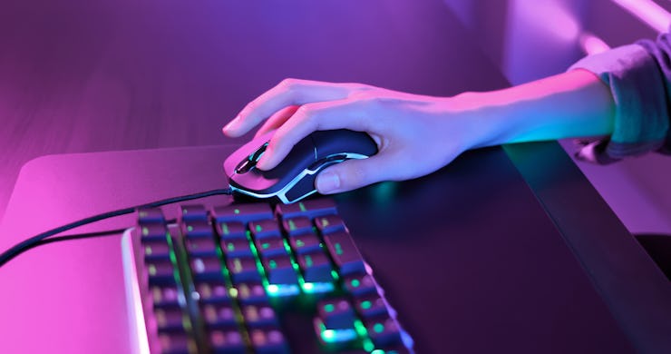 close up of pro cyber sport gamer play game with RGB keyboard and mouse
