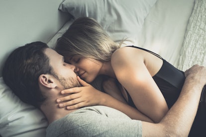 Taurus couple kissing in bed.