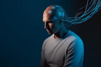 man with electrodes in his head is a futuristic concept of virtual reality and mind control. Neuro i...