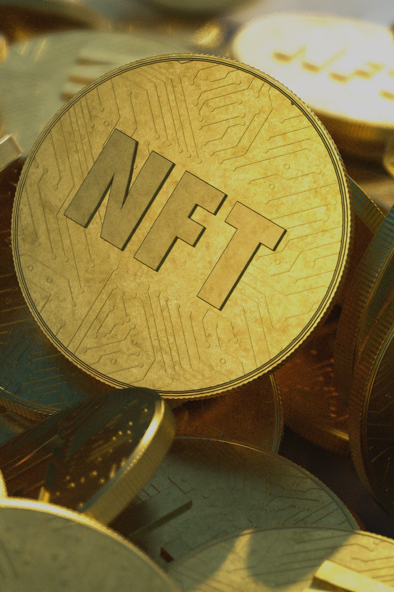 NFT golden coins in pile. Non fungible tokens dropped casually in a large pile, close-up shot. Embos...