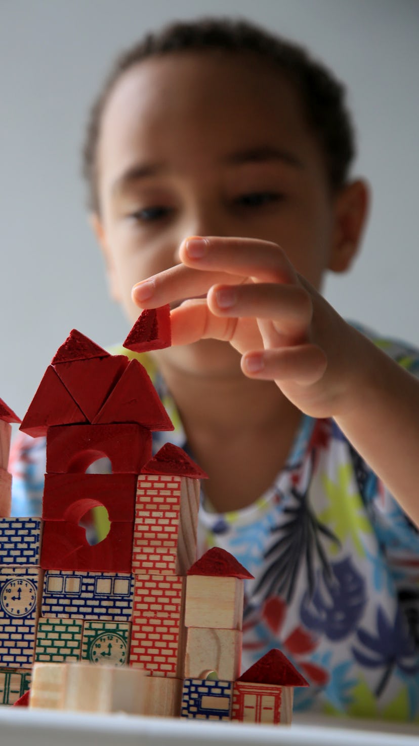 salvador, bahia, brazil - january 24, 2021: child playing with wooden block of children's constructi...