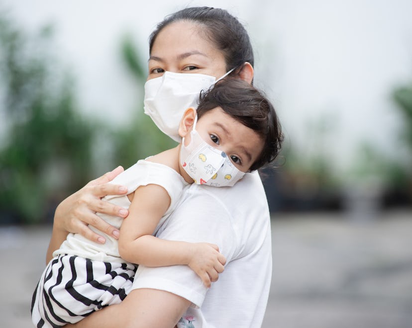 mom holding toddler, Covid vaccines for kids under 5 are almost approved