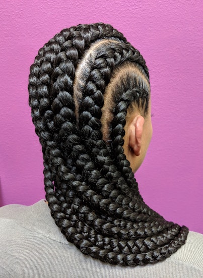 Afro Hair Braided In A Cornrow Hairstyle Using Black Synthetic Hair Extensions, Purple Background 