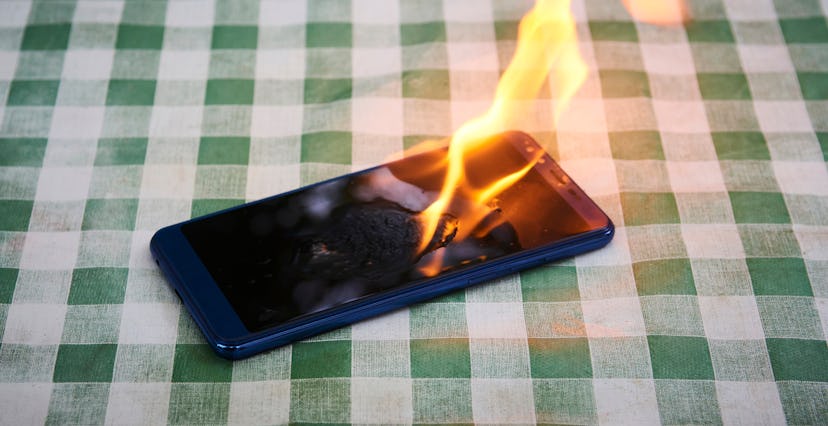 Mobile phone explodes and burns. Cell Phone explosion and fire. Smart Phone Danger from over use or ...