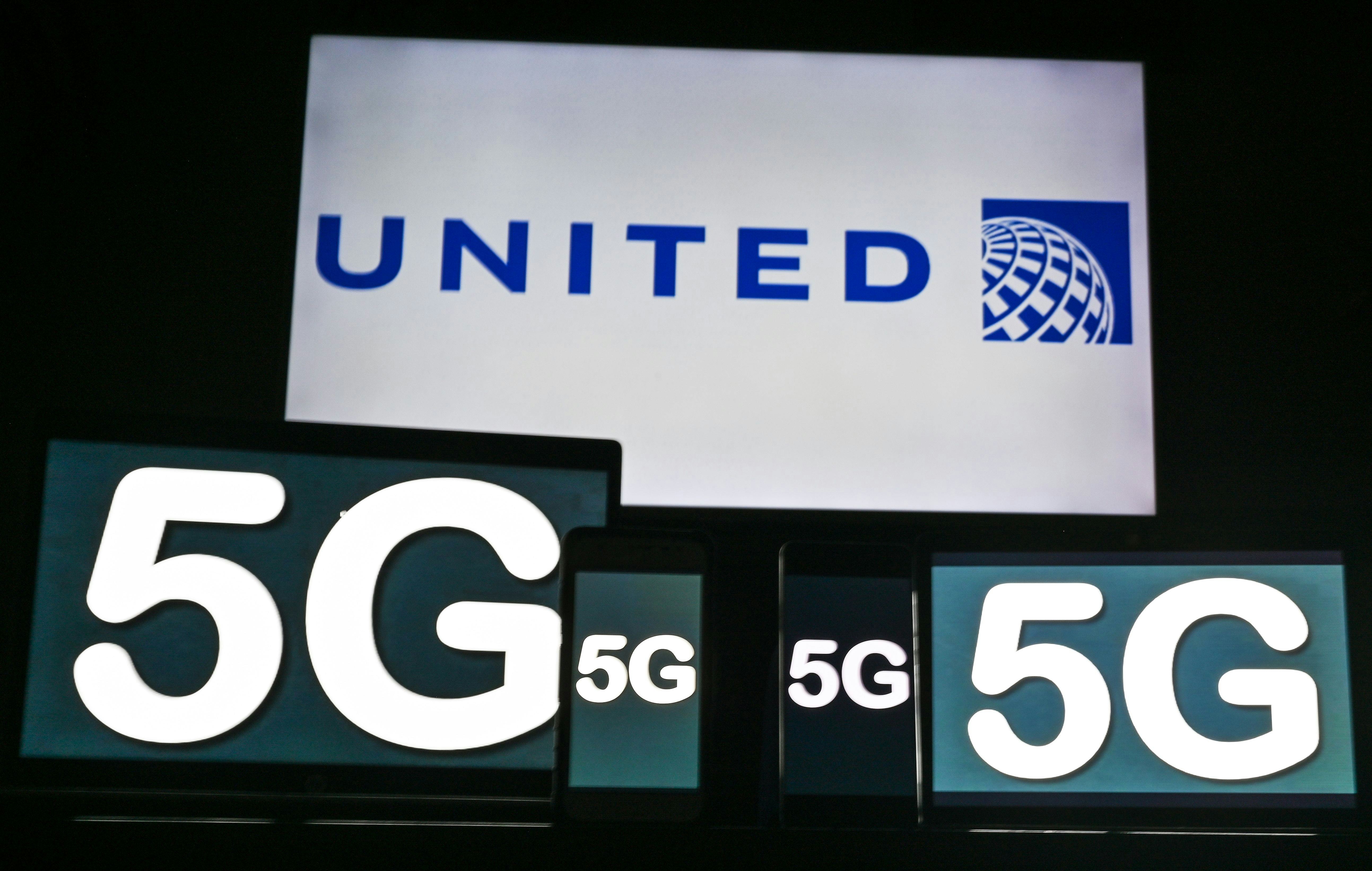 Images of the 5G sign displayed on the screens of mobile phones and computers in front of the United...