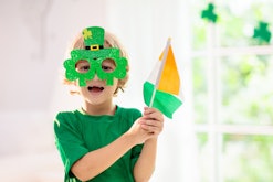 Family celebrating St. Patrick's Day. Irish holiday, culture and tradition. Kids wear green leprecha...