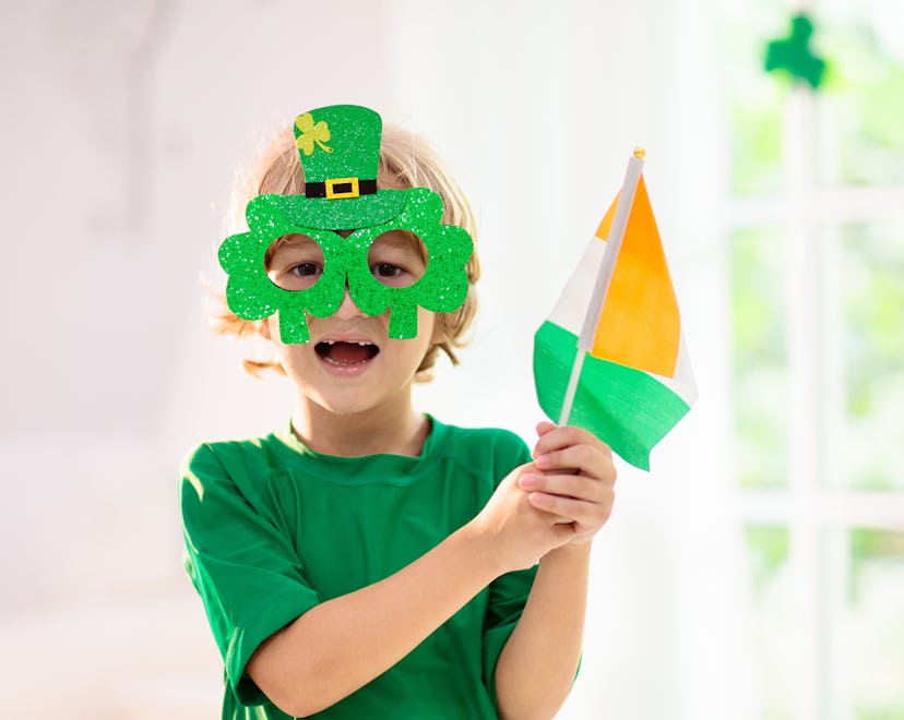 Family celebrating St. Patrick's Day. Irish holiday, culture and tradition. Kids wear green leprecha...