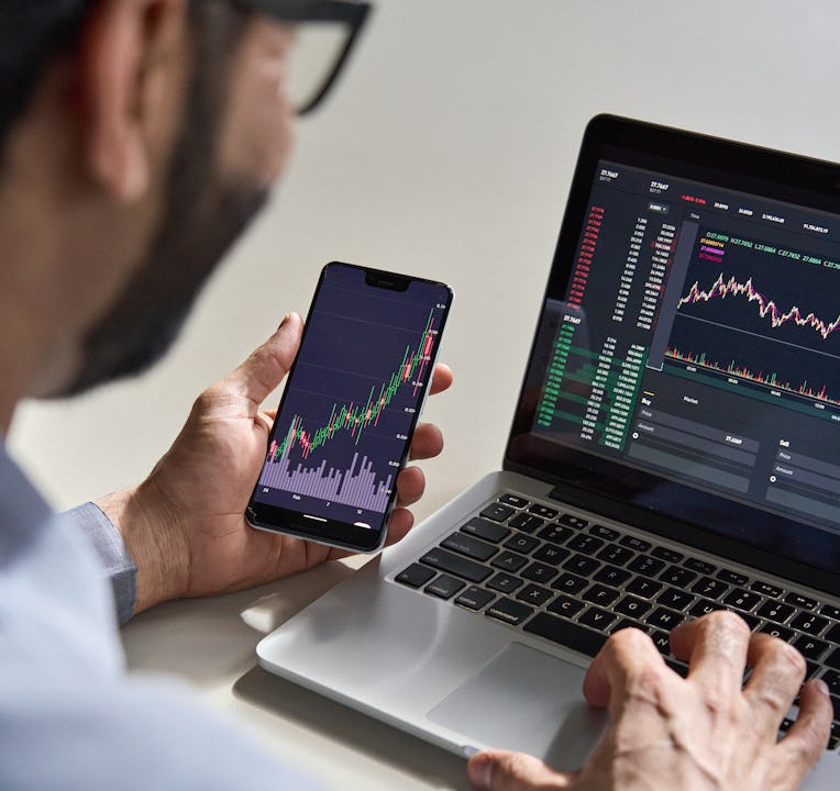 Business man trader investor analyst using mobile phone app analytics for cryptocurrency financial m...