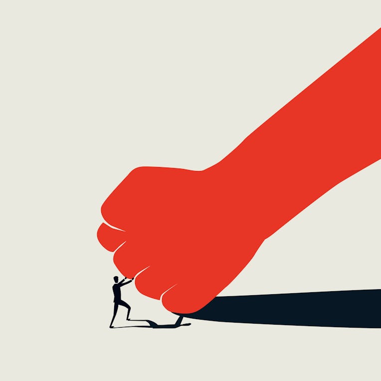 David vs Goliath business concept with small man fighting big fist. Standing up to bullies and oppre...