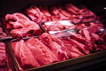 Butcher shop's meat window with meat packs. Different products in meat market. Meat counter.