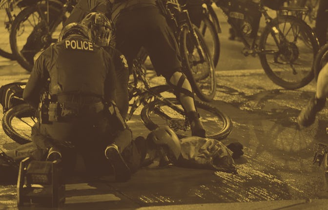 Police officers on bicycles arrest a person during a Black Lives Matter march and protest the night ...