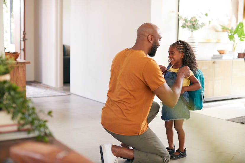 Father Saying Goodbye To Daughter As She Leaves Home For School