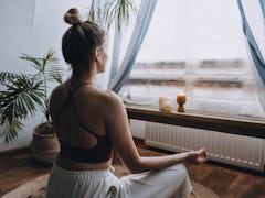 A woman does a guided morning meditation as a 15 minute routine.