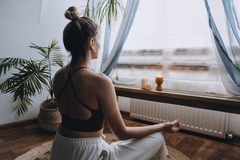 A woman does a guided morning meditation as a 15 minute routine.