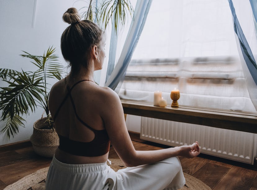 A woman does a guided morning meditation as a 15 minute routine.