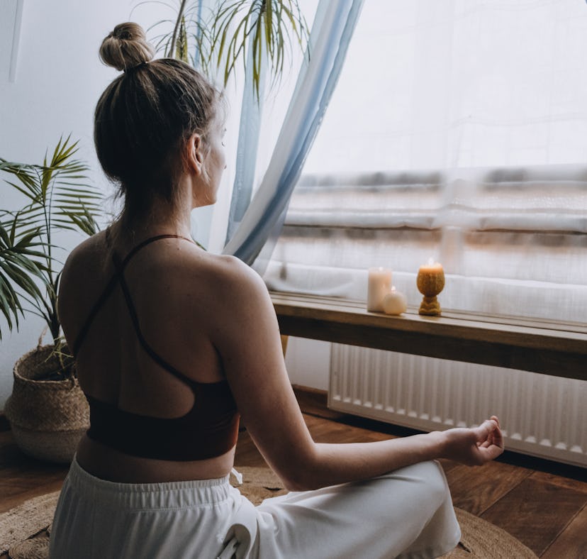 A woman does a guided morning meditation as a 15 minute routine.