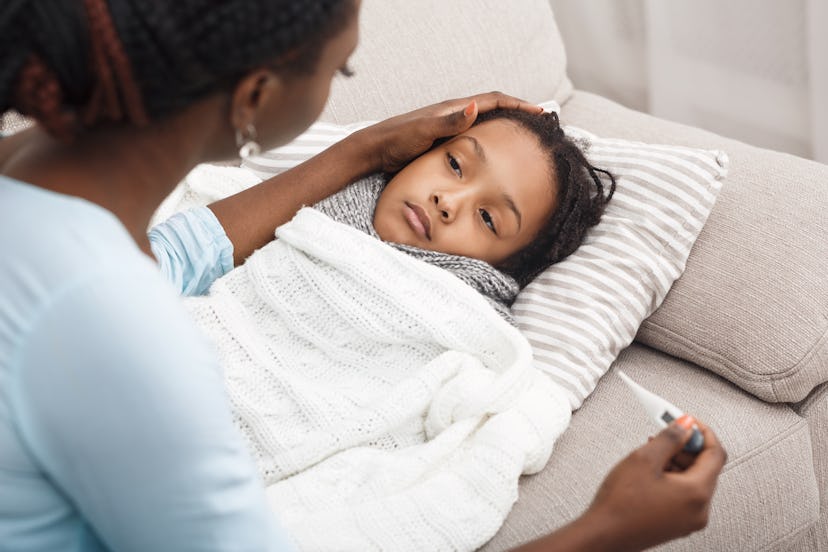 Mom comforting young girl in article about what to do when toddler is vomiting with no other symptom...