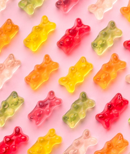 Flat lay composition with delicious jelly bears, jelly bears pattern on pink background
