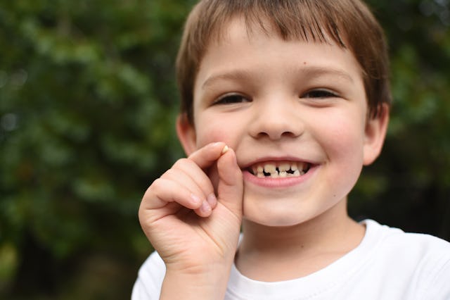 A boy smiling and showing his missing teeth. A woman recently shared her husband's family's lost too...