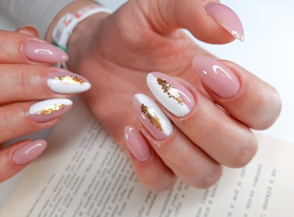 Abstract metallic nails featuring pink, gold, and white nail polish