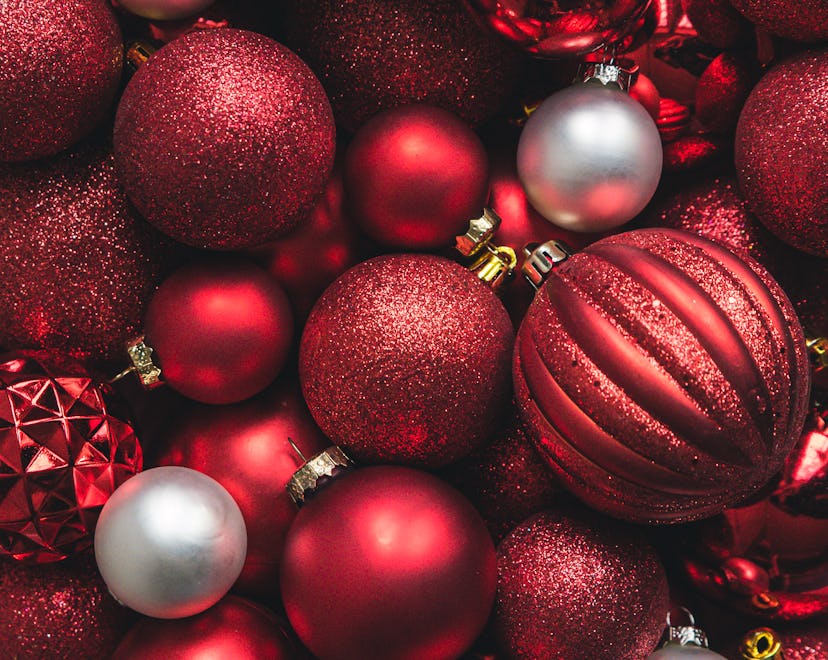 Close up of a variety of red and white Christmas ball ornaments.