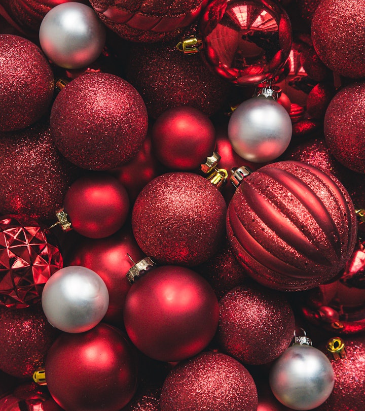 Close up of a variety of red and white Christmas ball ornaments.