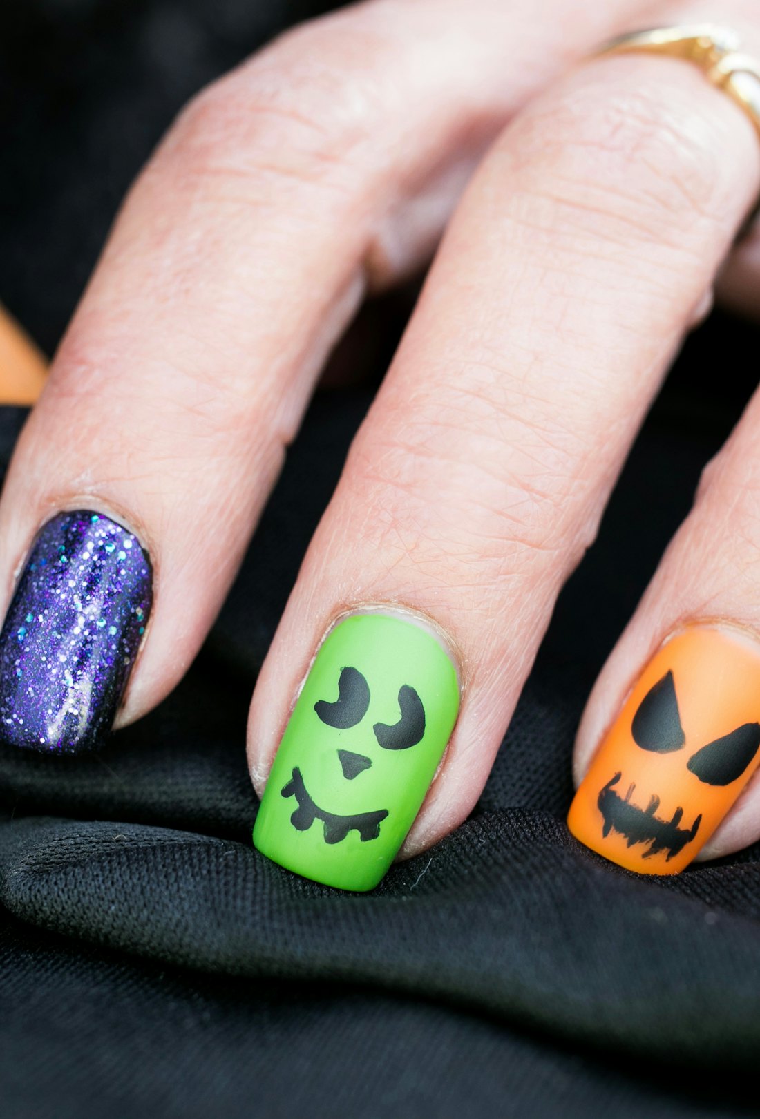 Halloween nails with monsters and jack-o'-lanterns.