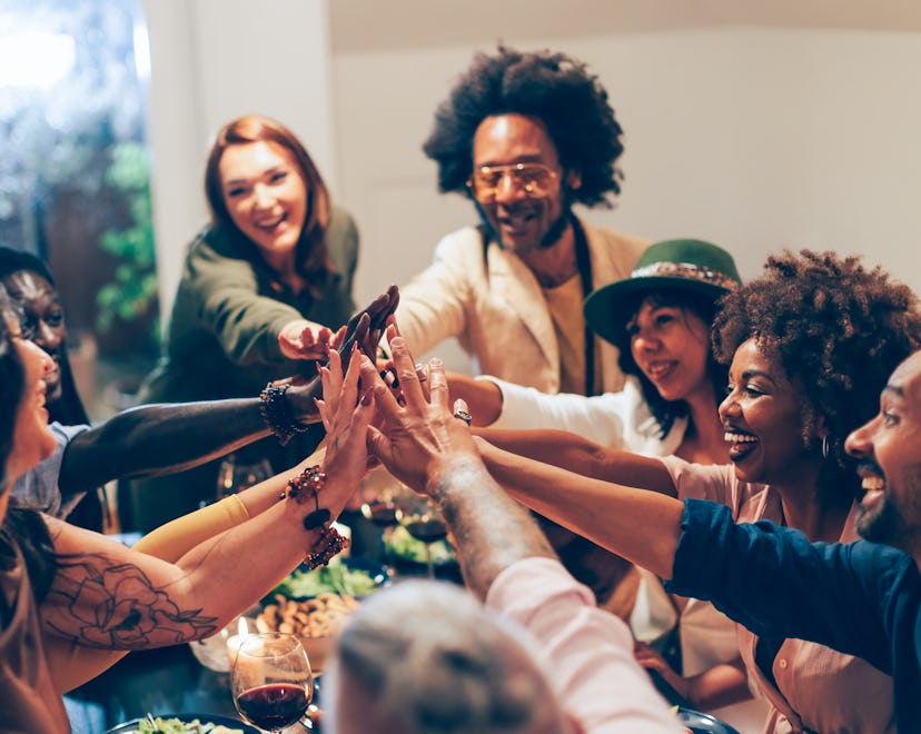 group of people having Friendsgiving in a round up of friendsgiving quotes