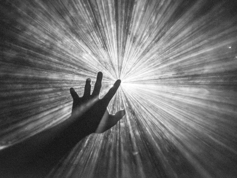 Hand reaches out to touch the light