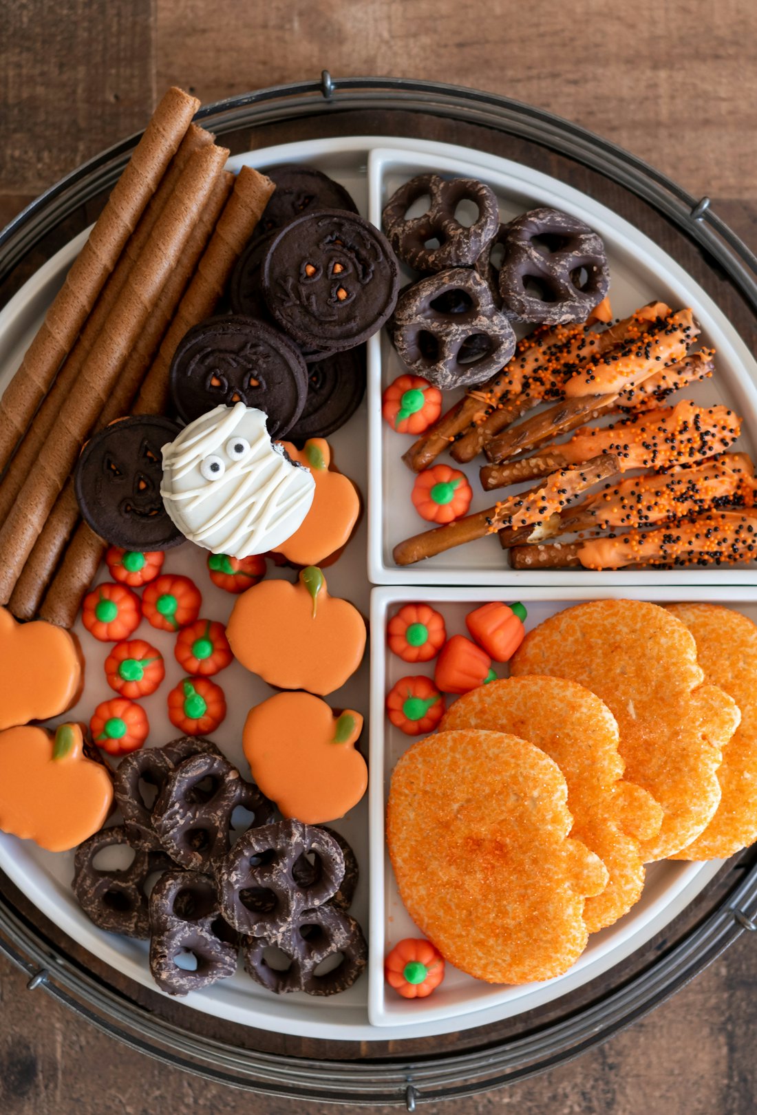 Halloween party charcuterie board with sweet treats, candy and cookies