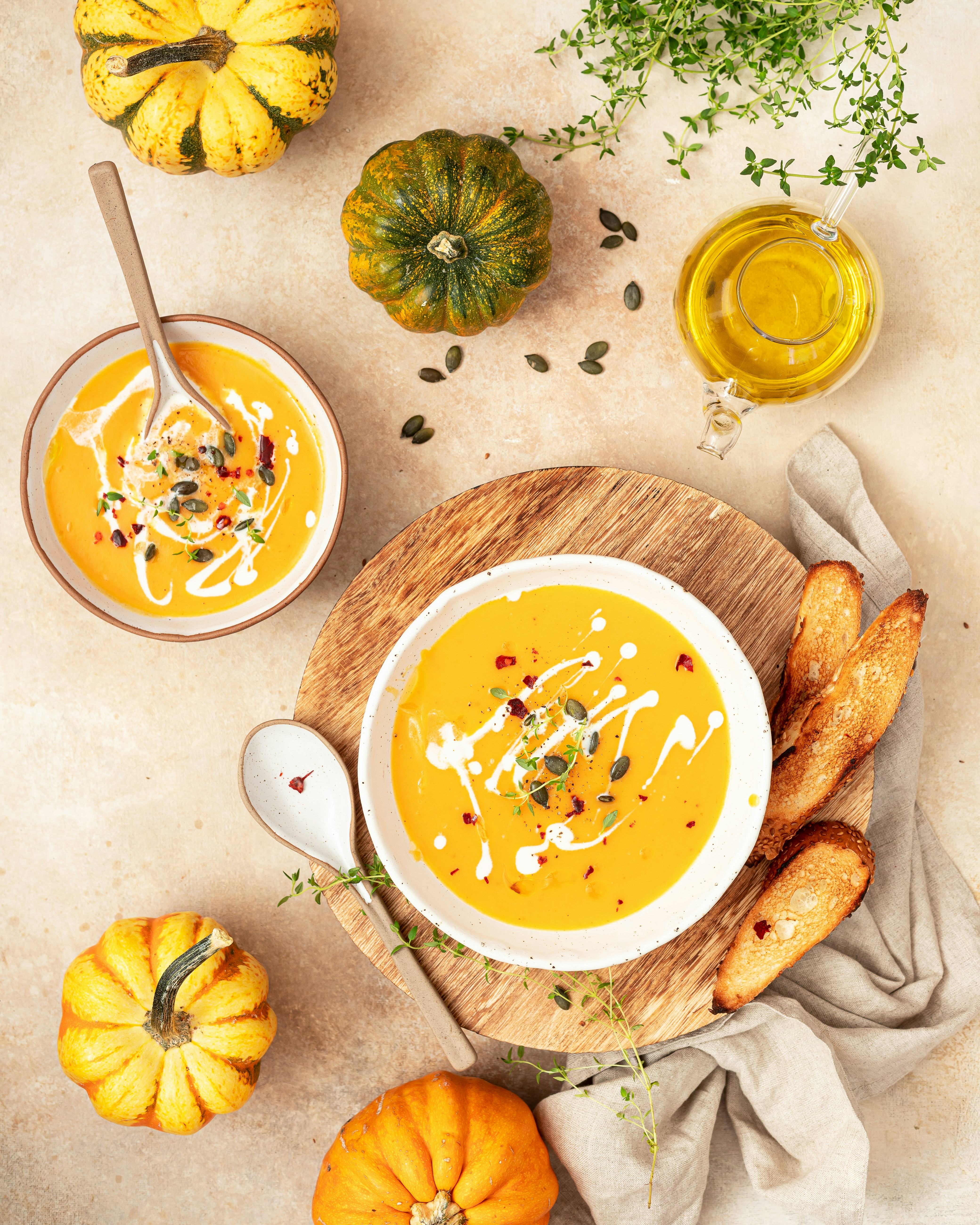 Vegetarian autumn pumpkin cream soup with spices, thyme and pumpkin seeds.