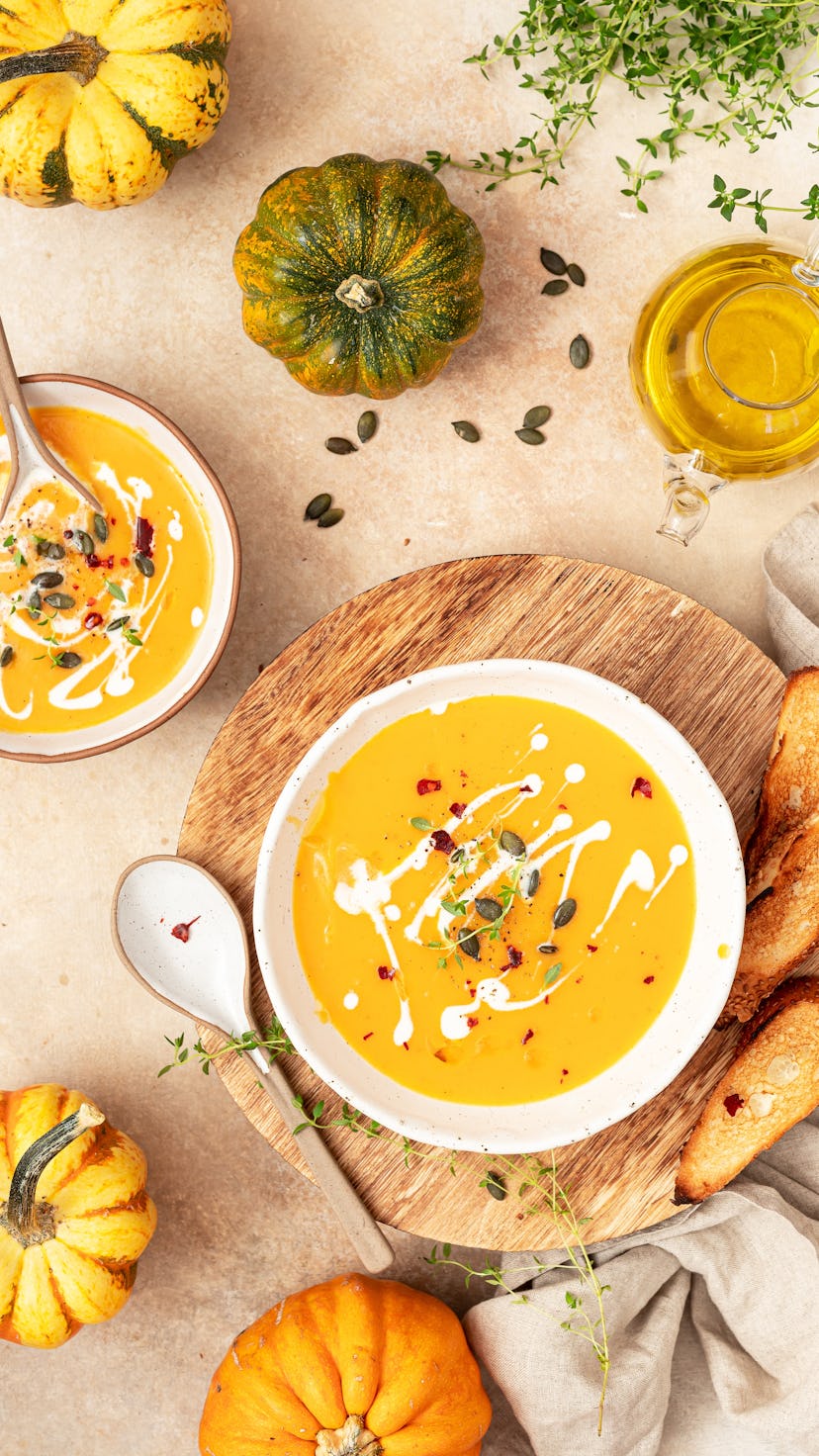 Vegetarian autumn pumpkin cream soup with spices, thyme and pumpkin seeds.