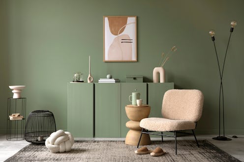 Stylish living room interior design with mock up poster frame, frotte armchair, wooden commode, side...