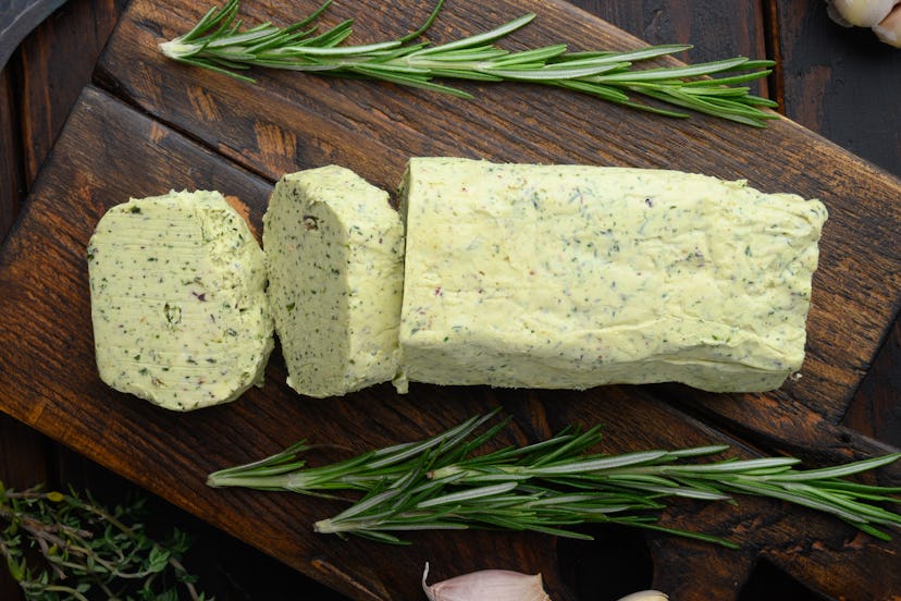 Farm Butter with a herb for sandwiches and steak set, on old dark wooden table background