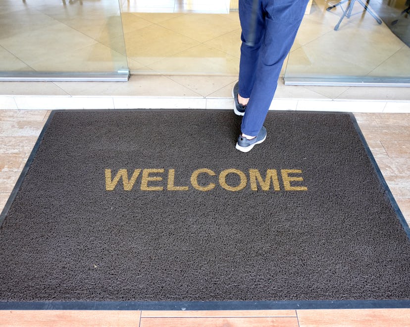 woman walking on welcome mat wondering what is closed Christmas Day 2022