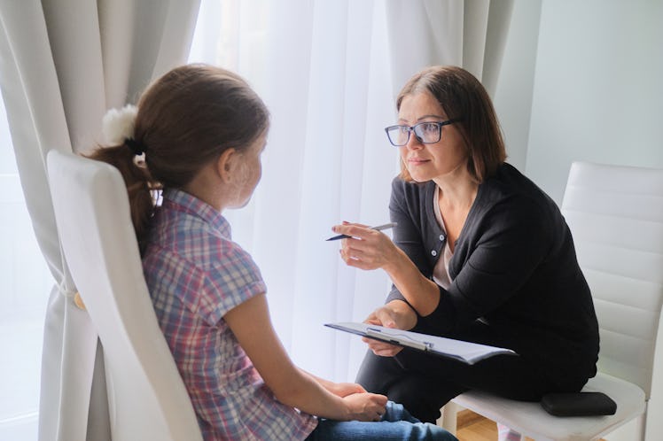 Social worker talking to girl.