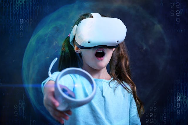 Child in VR glasses playing video games