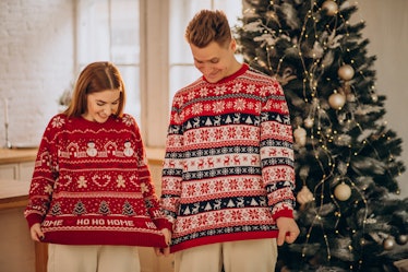 Couple wearing christmas sweaters together