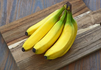 A lot of Fresh Cavendish Banana on wooden background. Health and benefits of Banana