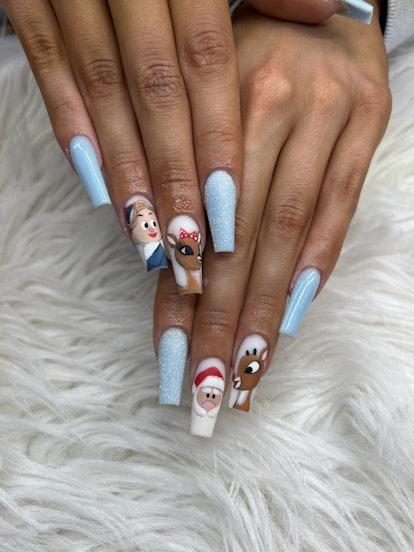A Christmas nail design with handpainted characters from "Rudolph The Red-Nosed Reindeer" movie and ...