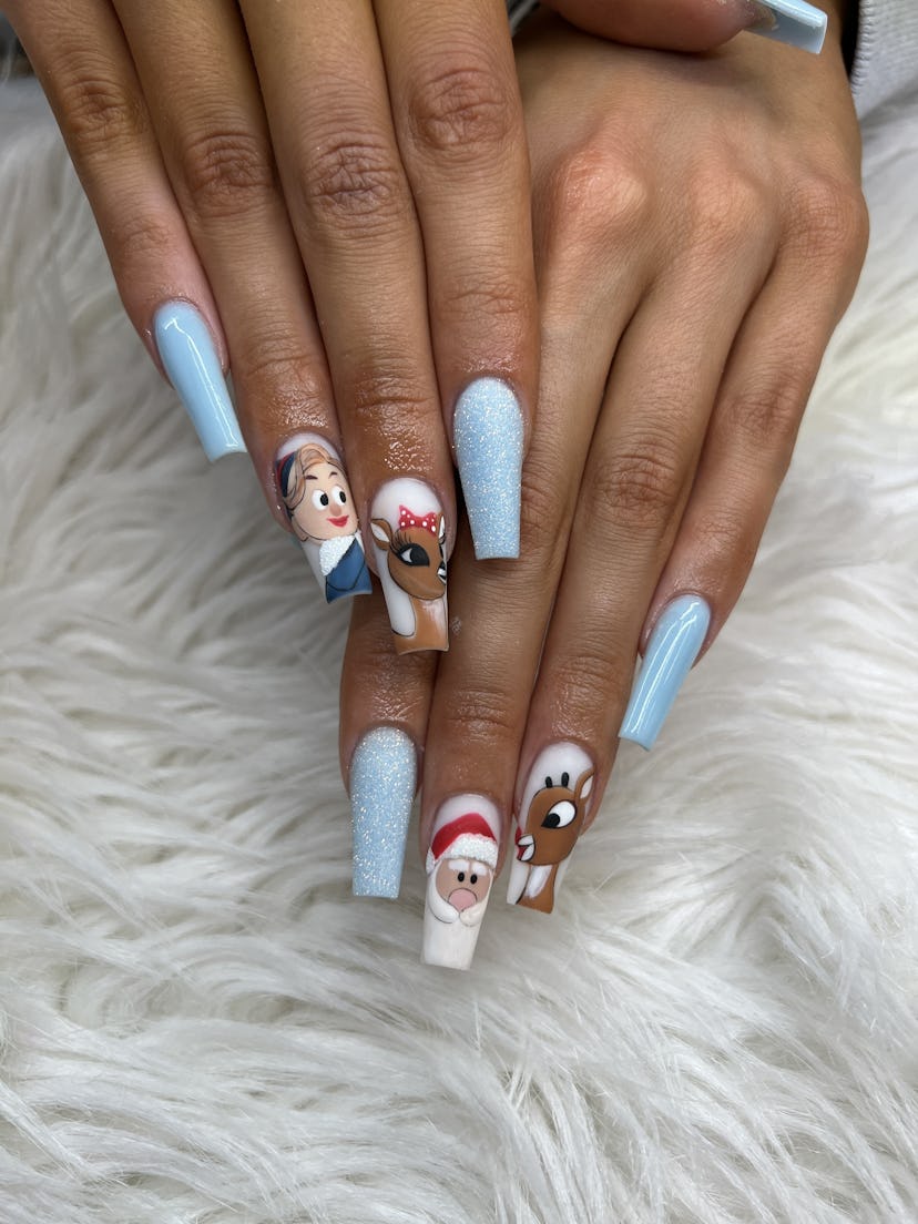 A Christmas nail design with handpainted characters from "Rudolph The Red-Nosed Reindeer" movie and ...
