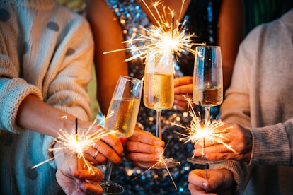 A champagne toast and sparklers to celebrate the New Year, an example of a photo you can pair with N...