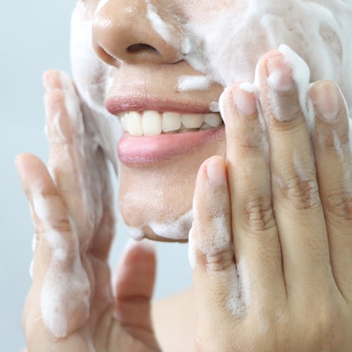 Close up of Asian woman washing face