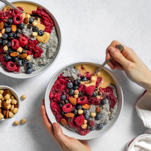 Peanut butter and jelly vegan chia pudding bowl being eaten for breakfast. Made of chia seeds, almon...