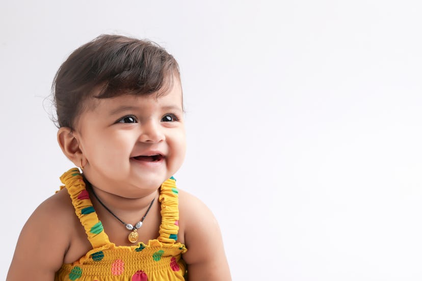 A smiling Indian baby girl. Girl names that start with J include Jewel, which is classic and also un...