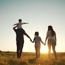 Happy family walk in field in nature.Parents and children are free and active people in nature.Healt...