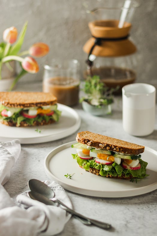 Healthy, natural spring breakfast or brunch. Serving of sandwiches with whole grain bread, avocado, ...