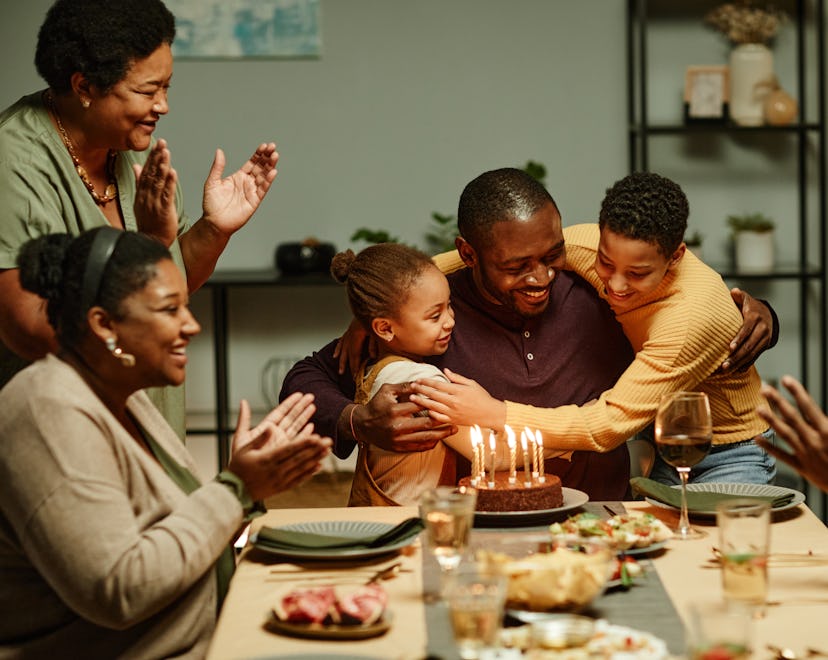 family around a table for a father's birthday embracing their family traditions